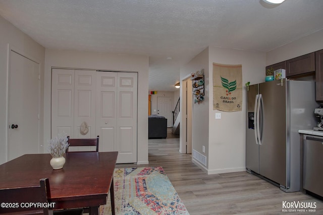 767 N Yakima St, Wasilla, AK 99654 - dining space featuring light wood-type flooring and a textured ceiling