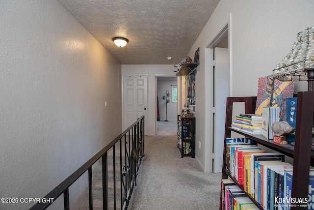 767 N Yakima St, Wasilla, AK 99654 - hallway featuring a textured ceiling, carpet flooring, and a textured wall