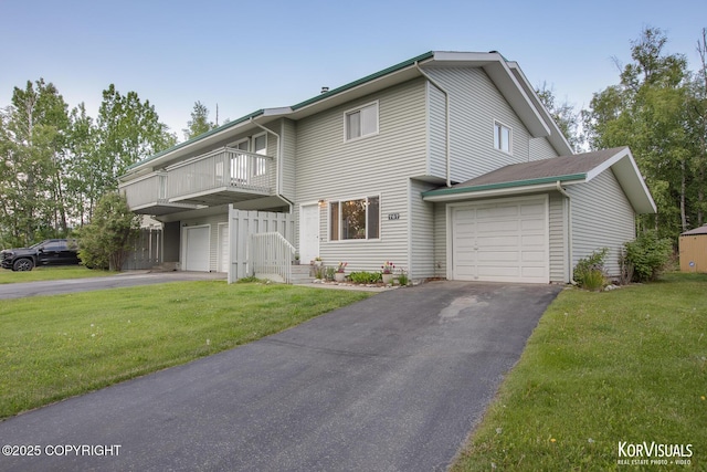 767 N Yakima St, Wasilla, AK 99654 - view of front of house with driveway, a balcony, a front lawn, and a garage