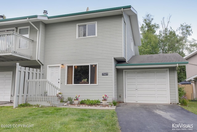 767 N Yakima St, Wasilla, AK 99654 - multi unit property with a balcony, driveway, a garage, and a front lawn