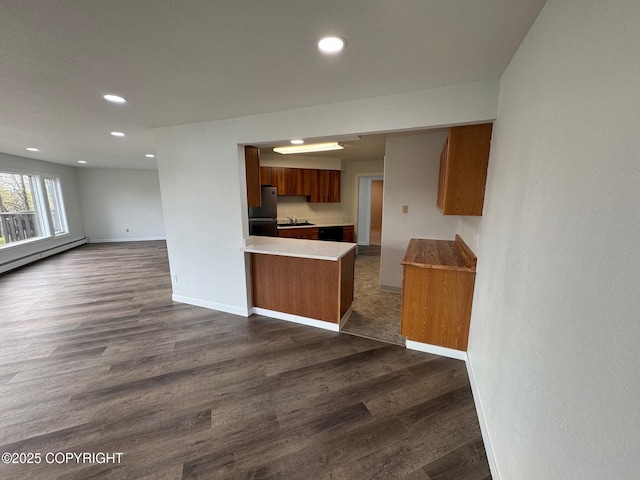 1430 Bridgeway St # 3, Anchorage, AK 99501 - kitchen with freestanding refrigerator, brown cabinets, open floor plan, a sink, and dark wood-type flooring