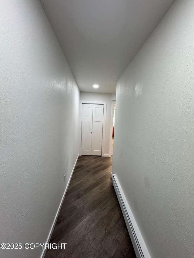 1430 Bridgeway St # 3, Anchorage, AK 99501 - hallway with dark wood-style flooring, a baseboard heating unit, baseboards, recessed lighting, and a textured wall
