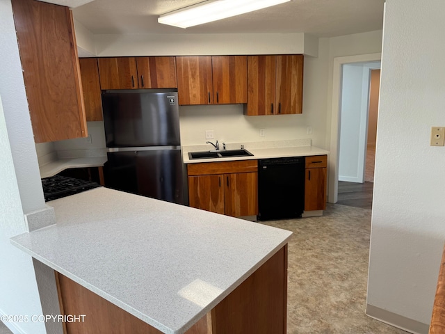 1430 Bridgeway St # 3, Anchorage, AK 99501 - kitchen with dishwasher, freestanding refrigerator, a sink, and light countertops