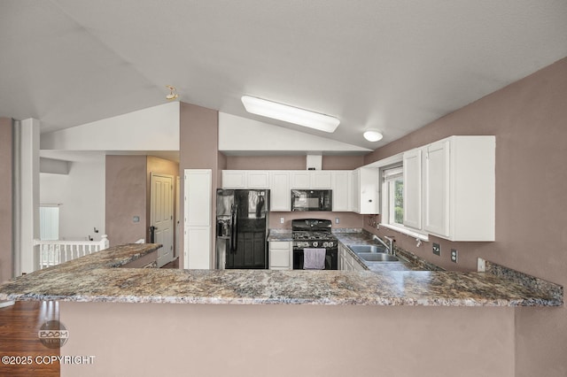 3933 Sycamore Loop, Anchorage, AK 99504 - kitchen with black appliances, a sink, light stone counters, lofted ceiling, and white cabinets