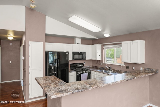 3933 Sycamore Loop, Anchorage, AK 99504 - kitchen featuring black appliances, a sink, vaulted ceiling, a peninsula, and white cabinets