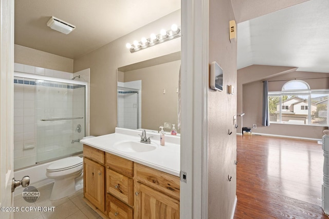 3933 Sycamore Loop, Anchorage, AK 99504 - bathroom featuring vanity, toilet, bath / shower combo with glass door, and wood finished floors
