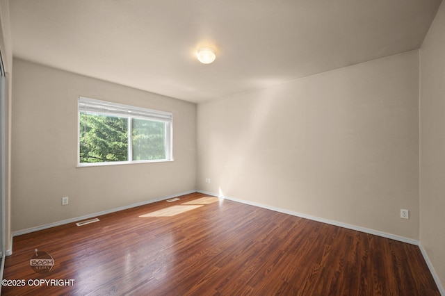 3933 Sycamore Loop, Anchorage, AK 99504 - spare room with wood finished floors and baseboards