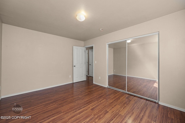3933 Sycamore Loop, Anchorage, AK 99504 - unfurnished bedroom with wood finished floors, baseboards, and a closet