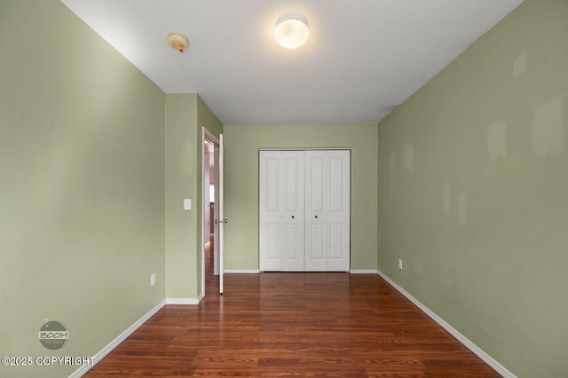 3933 Sycamore Loop, Anchorage, AK 99504 - unfurnished bedroom featuring wood finished floors, baseboards, and a closet