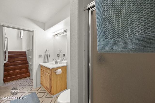 3933 Sycamore Loop, Anchorage, AK 99504 - bathroom with vanity, toilet, and an enclosed shower