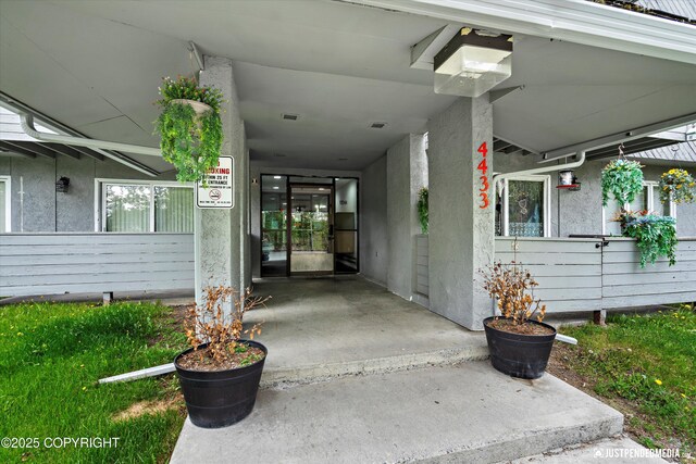 4433 San Ernesto Ave # 104, Anchorage, AK 99508 - view of exterior entry with stucco siding