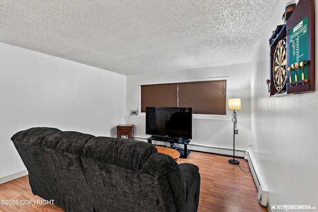 4433 San Ernesto Ave # 104, Anchorage, AK 99508 - living area featuring wood finished floors, a baseboard heating unit, a textured ceiling, and baseboards