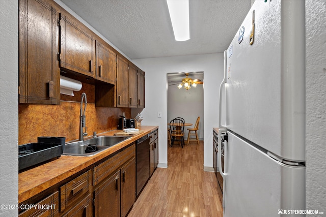 4433 San Ernesto Ave # 104, Anchorage, AK 99508 - kitchen featuring freestanding refrigerator, dishwasher, a sink, light wood finished floors, and tasteful backsplash