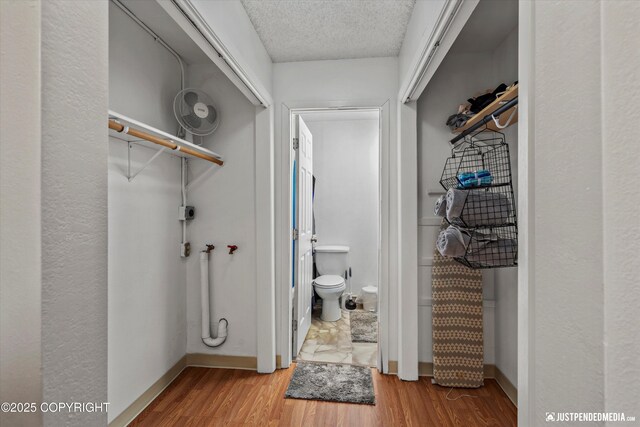 4433 San Ernesto Ave # 104, Anchorage, AK 99508 - bathroom featuring toilet, wood finished floors, baseboards, and a textured ceiling