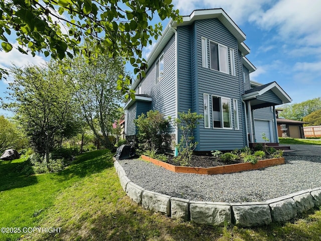 4259 Shirley Ct, Homer, AK 99603 - view of side of property featuring a garage and a lawn