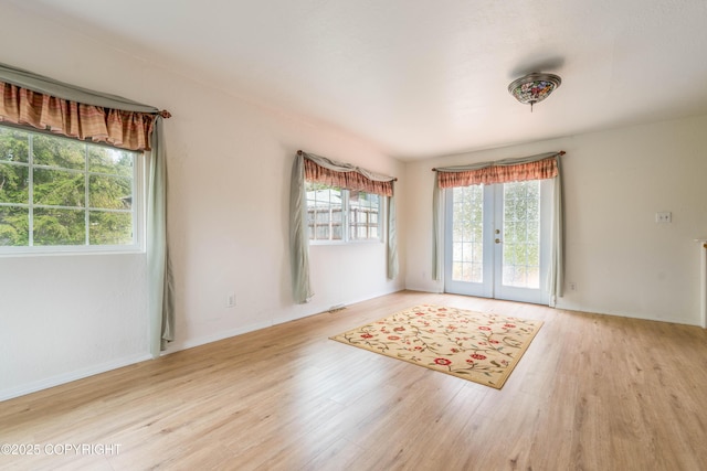 701 Buren Rd, Ketchikan, AK 99901 - spare room featuring french doors, wood finished floors, and baseboards