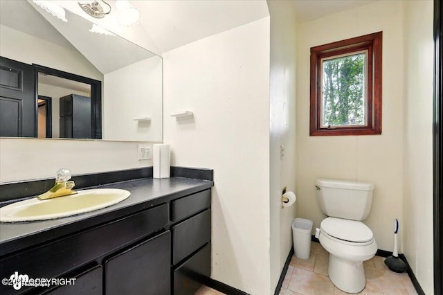 4821 S Outrigger Dr, Wasilla, AK 99654 - half bath with toilet, vanity, baseboards, tile patterned floors, and vaulted ceiling