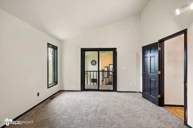 4821 S Outrigger Dr, Wasilla, AK 99654 - empty room featuring lofted ceiling, carpet, and baseboards
