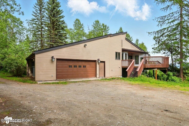 4821 S Outrigger Dr, Wasilla, AK 99654 - view of side of property with a wooden deck, dirt driveway, and stairs