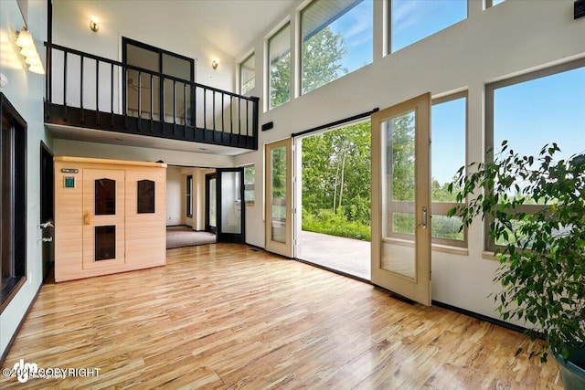 4821 S Outrigger Dr, Wasilla, AK 99654 - unfurnished living room featuring a high ceiling and wood finished floors