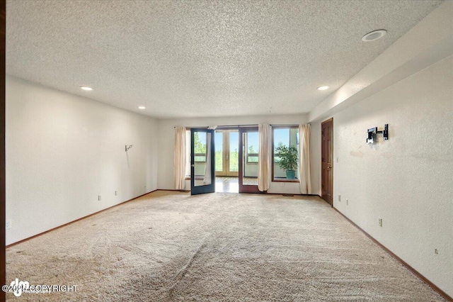 4821 S Outrigger Dr, Wasilla, AK 99654 - empty room with light colored carpet, a textured ceiling, recessed lighting, a textured wall, and baseboards