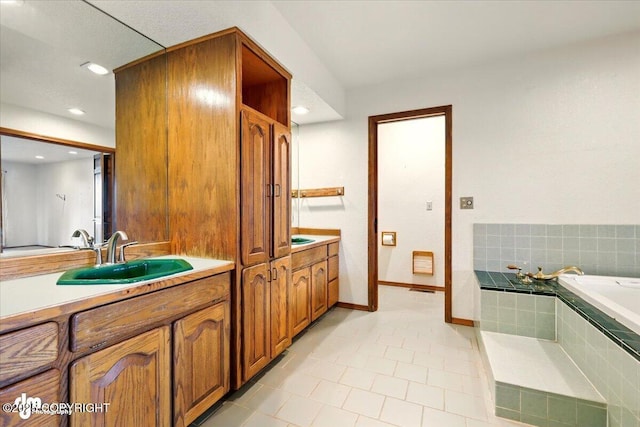 4821 S Outrigger Dr, Wasilla, AK 99654 - bathroom featuring vanity, a bath, tile patterned floors, baseboards, and recessed lighting