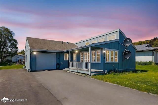 4661 Rochelle Rd, Homer, AK 99603 - view of front of home featuring an attached garage, covered porch, and asphalt driveway