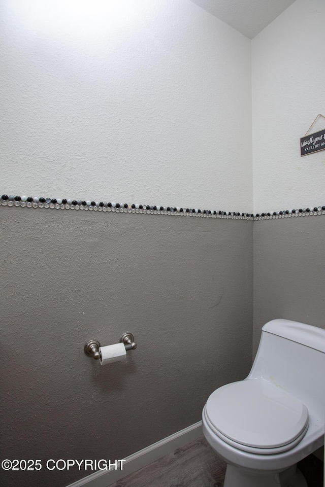 1701 Russian Jack Dr # D3, Anchorage, AK 99508 - bathroom with toilet, wood finished floors, and baseboards