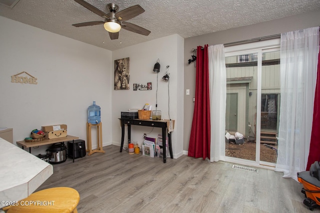 1701 Russian Jack Dr # D3, Anchorage, AK 99508 - dining area featuring wood finished floors, ceiling fan, a textured ceiling, and baseboards