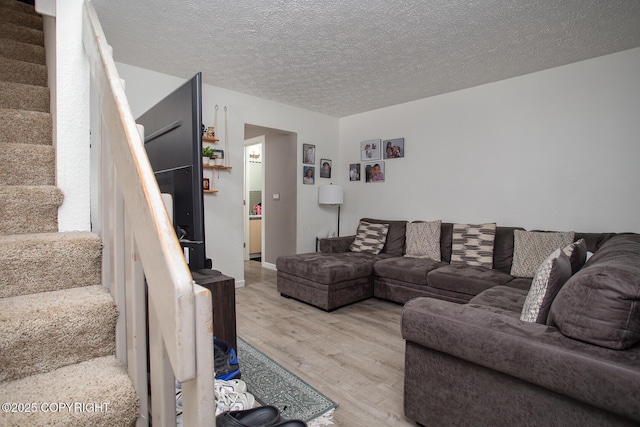 1701 Russian Jack Dr # D3, Anchorage, AK 99508 - living area featuring light wood-style floors, stairs, and a textured ceiling