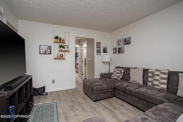 1701 Russian Jack Dr # D3, Anchorage, AK 99508 - living area featuring wood finished floors, a textured ceiling, and baseboards