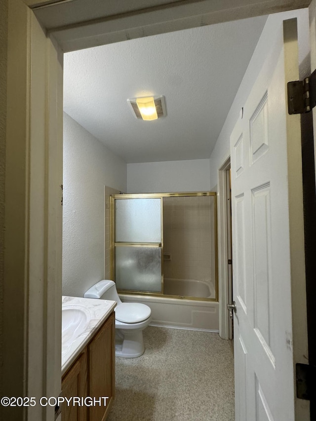 1701 Russian Jack Dr # D3, Anchorage, AK 99508 - bathroom featuring toilet, vanity, and bath / shower combo with glass door