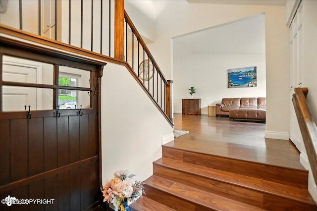 12900 Wellsford Cir, Anchorage, AK 99516 - entrance foyer featuring stairway, wood finished floors, a towering ceiling, and baseboards