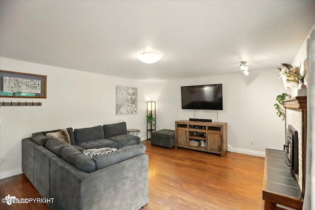 12900 Wellsford Cir, Anchorage, AK 99516 - living area featuring wood finished floors, baseboards, and a fireplace
