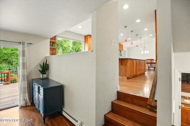 12900 Wellsford Cir, Anchorage, AK 99516 - stairs featuring baseboard heating, wood finished floors, and recessed lighting