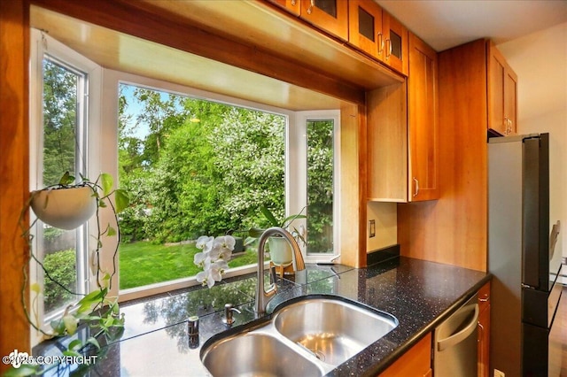 12900 Wellsford Cir, Anchorage, AK 99516 - kitchen featuring a sink, appliances with stainless steel finishes, brown cabinetry, glass insert cabinets, and dark stone counters