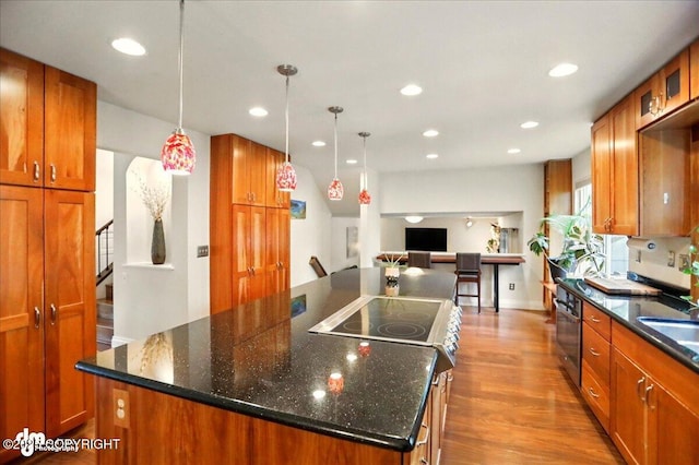 12900 Wellsford Cir, Anchorage, AK 99516 - kitchen featuring a kitchen island, wall oven, brown cabinets, recessed lighting, and wood finished floors