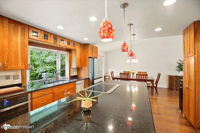 12900 Wellsford Cir, Anchorage, AK 99516 - kitchen with appliances with stainless steel finishes, a sink, brown cabinetry, recessed lighting, and decorative light fixtures