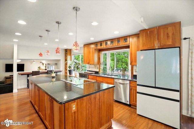 12900 Wellsford Cir, Anchorage, AK 99516 - kitchen with dishwasher, freestanding refrigerator, a sink, brown cabinets, and a center island
