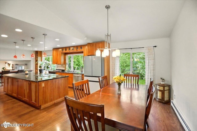 12900 Wellsford Cir, Anchorage, AK 99516 - dining room with baseboard heating, wood finished floors, plenty of natural light, and recessed lighting