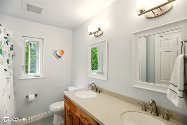 12900 Wellsford Cir, Anchorage, AK 99516 - full bath with toilet, double vanity, and a shower with shower curtain