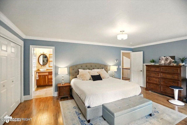 12900 Wellsford Cir, Anchorage, AK 99516 - bedroom featuring wood finished floors, crown molding, and ensuite bath
