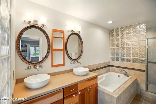 12900 Wellsford Cir, Anchorage, AK 99516 - bathroom with a bath, double vanity, a tile shower, and recessed lighting