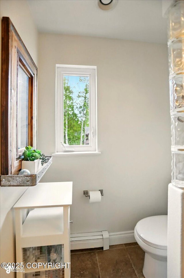 12900 Wellsford Cir, Anchorage, AK 99516 - bathroom featuring toilet, baseboard heating, baseboards, and tile patterned floors