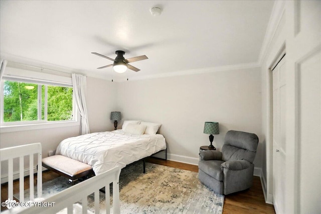 12900 Wellsford Cir, Anchorage, AK 99516 - bedroom featuring radiator, ornamental molding, wood finished floors, baseboards, and a closet