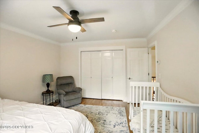 12900 Wellsford Cir, Anchorage, AK 99516 - bedroom featuring wood finished floors, a closet, ornamental molding, and a ceiling fan