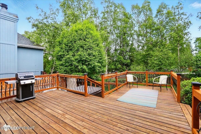 12900 Wellsford Cir, Anchorage, AK 99516 - wooden deck featuring a grill and view of wooded area