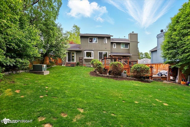 12900 Wellsford Cir, Anchorage, AK 99516 - back of house featuring a deck, a lawn, a chimney, and entry steps