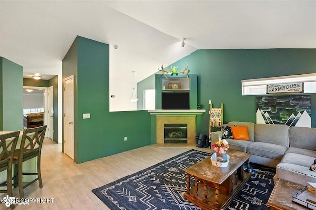 11437 Spyglass Hill Cir, Anchorage, AK 99515 - living room with wood finished floors, lofted ceiling, and a tile fireplace
