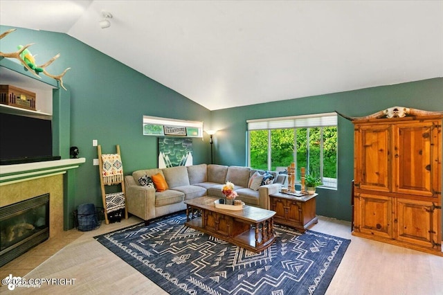 11437 Spyglass Hill Cir, Anchorage, AK 99515 - living area featuring lofted ceiling, a fireplace, and light wood-type flooring